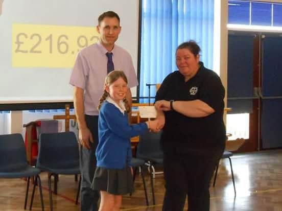 Evie Wood presents the cheque to Yvonne Andrews. JctM-YnHU7vgAMEGPdTJ
