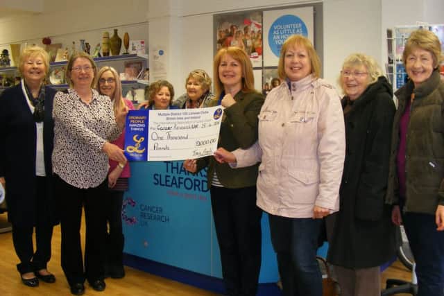 Sleaford Lionesses present ?1,000 to the Cancer Research UK shop in town. Anne Brown, the new shop manager is pictured with Tracy Arnold, Lionesses president, watched by previous shop manager Marjorie Johnson and other volunteers and Lionesses. EMN-160505-112217001