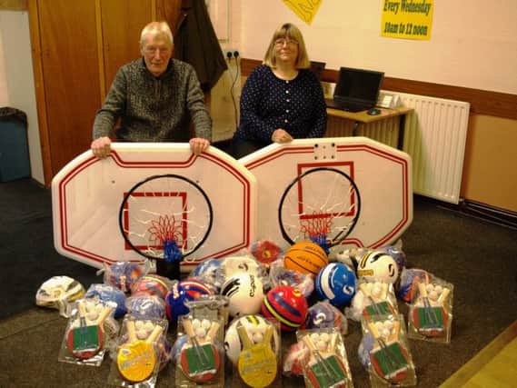 Brian and Sue Dickinson donate new sports kit for youngsters in Sutton on Sea.