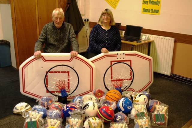 Brian and Sue Dickinson donate new sports kit for youngsters in Sutton on Sea.