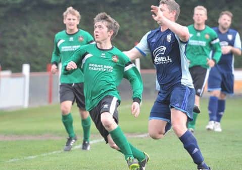 Sleaford Town Reserves defender Jack Padley (left) is put under pressure by Hykeham's Ben Good. Photo: Nigel West