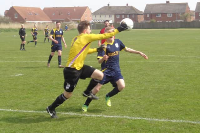 Chapel Swifts' goalkeeper Danny Kay and Stuart Parnell battle for the ball.