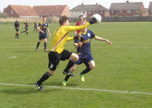 Chapel Swifts' goalkeeper Danny Kay and Stuart Parnell battle for the ball.