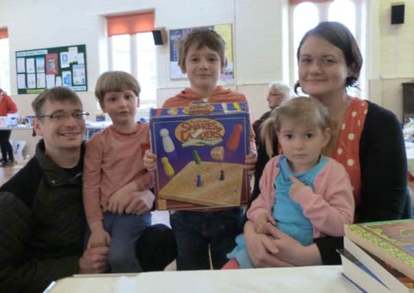 The Mannion family, from left David, William, Edward, Kathy and Aliena with the Snakes and Ladder  game they purchased at Caistor Methodist fair. (Lin) EMN-160522-191929001