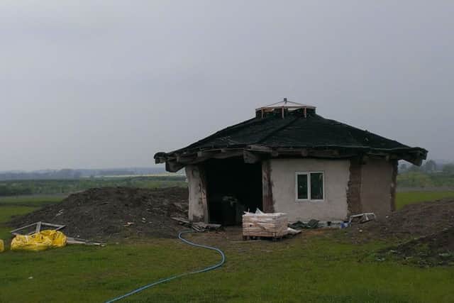 The lime rendered animal shelter has been built out of straw bales, recycled material and the thatched roof is supported on reciprocal beams. EMN-160516-095114001