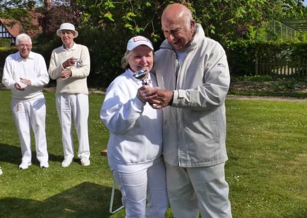 Pauline Donner receiving the Lincoln Singles Cup from chairman Bob Potter. Onlookers are Roy Donner and Ralph Timms who finished third and second respectively.