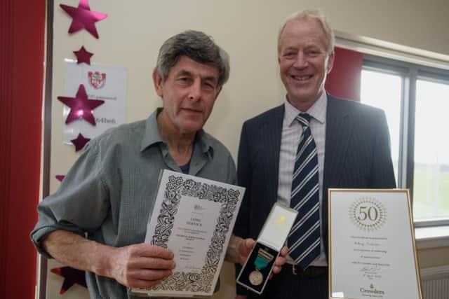 Tony Tomlinson, left, receiving his long service award.
Photo by Steve Smailes Photography. All rights reserved. EMN-160517-090449001