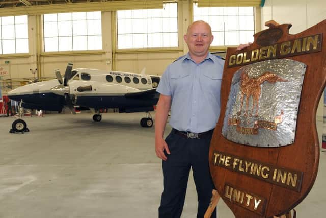 45(Reserve) Squadron media event at RAF Cranwell. Squadron Executive Officer Sqd Ldr Jonny Lawson with a 1920's flying camel nose cone off a Vickers Vernon airsraft. EMN-160524-105832001