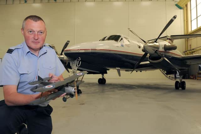 45(Reserve) Squadron media event at RAF Cranwell. Flt Lt Tony Hall with a model Sopwith 1 1/2 Strutter, the first aircraft for 45 Squadron in 1917, pictured with the squadron's latest aircraft, a Kingair B200 GT. EMN-160524-105701001