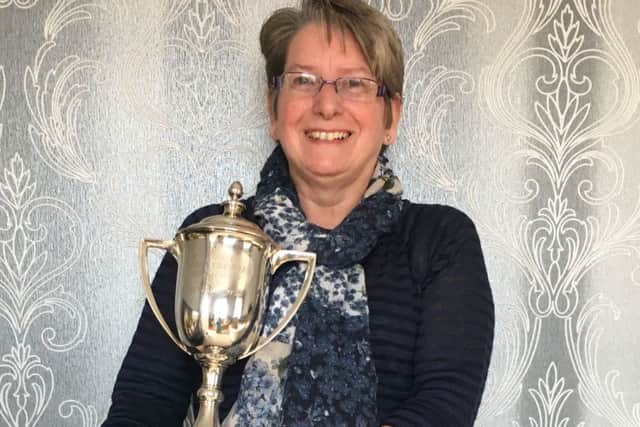 Jane Taylor with the Harry Farnsworth Memorial Cup for Bandsmanship. ANL-160524-130526001