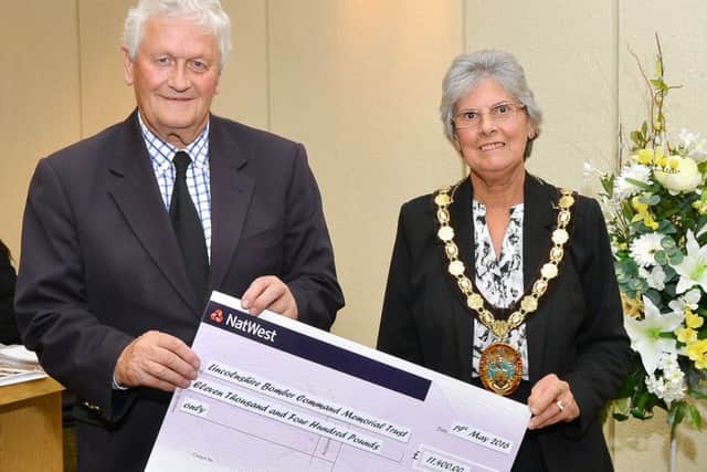 Coun Gill Ogden presents a cheque to Tony Worth of the International Bomber Command Memorial Trust.