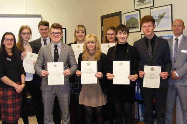 Photography students at St George's Academy with their certificates of licentiateship along with Head of Photography Carla Ferrier and teacher John Caslin. EMN-160526-160707001