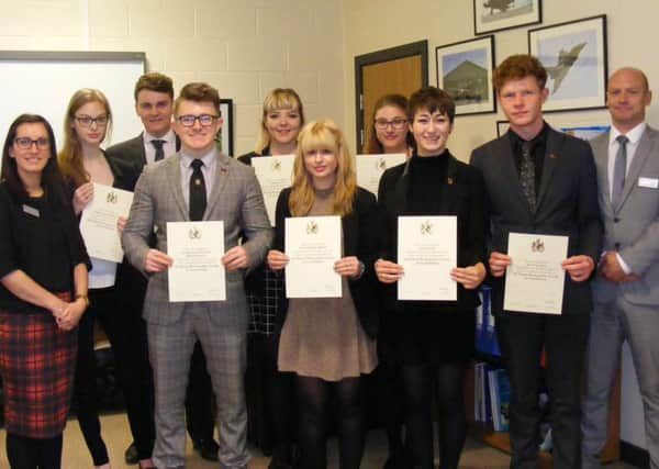 Photography students at St George's Academy with their certificates of licentiateship along with Head of Photography Carla Ferrier and teacher John Caslin. EMN-160526-160707001