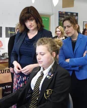 Ms Atkins and Ms Morgan (left) watch a student at work EMN-160525-151739001