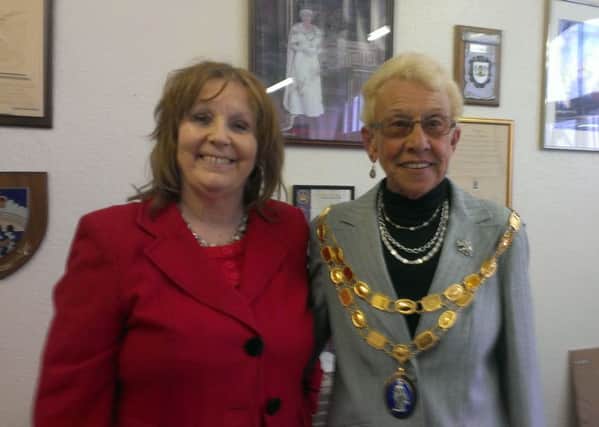 Coun Julia Pears (left) hands over the chain of office to new Spilsby Mayor Coun Gill Rymer. ANL-160527-084515001