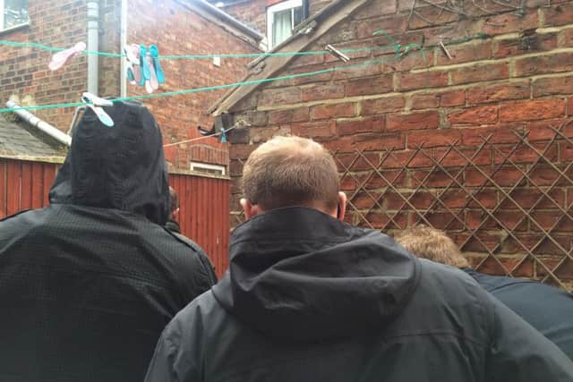 Covert officers lie in wait to raid the premises.