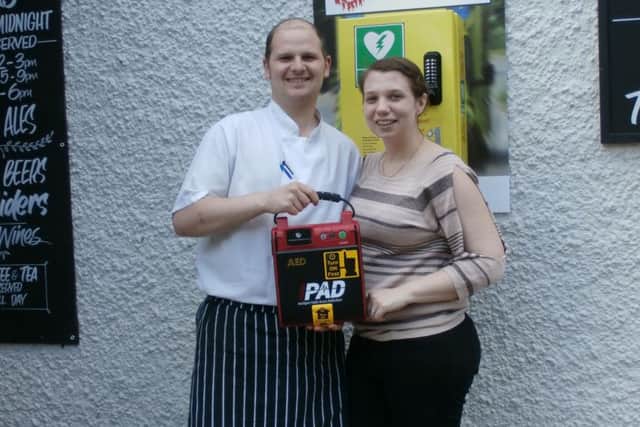 Rob and Mel Wild with the defibrillator outside The Red Lion in Mumby.