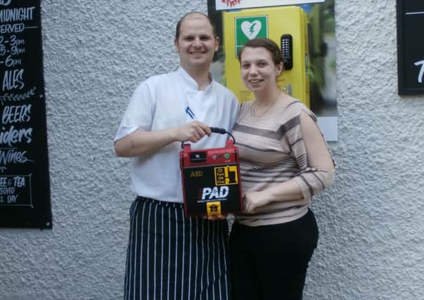 Rob and Mel Wild with the defibrillator outside The Red Lion in Mumby.