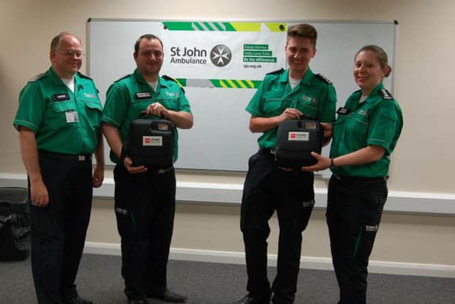 Peter Howie, John Dawson, Jordan Herd and Lisa Sanguy from St John Ambulance with the new defibrillator.