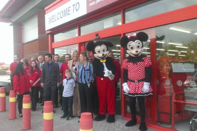 Staff of the new Poundstretcher store in Skegness ready to welcome customers, along with Mayor of Skegness Coun Dick Edginton and Mickey and Minnie Mouse. ANL-160529-103231001