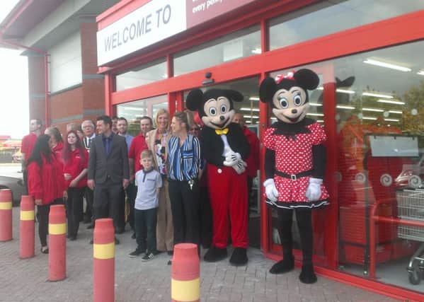 Staff of the new Poundstretcher store in Skegness ready to welcome customers, along with Mayor of Skegness Coun Dick Edginton and Mickey and Minnie Mouse. ANL-160529-103231001