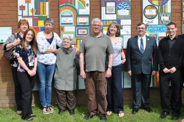 MEMORY LANE: Carol Parker (third left) with dementia patients and guests at the unveiling of a new mosaic.