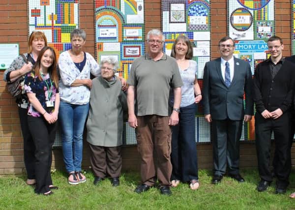 MEMORY LANE: Carol Parker (third left) with dementia patients and guests at the unveiling of a new mosaic.