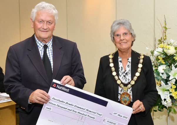 Coun Gill Ogden presents a cheque to Tony Worth of the International Bomber Command Memorial Trust.