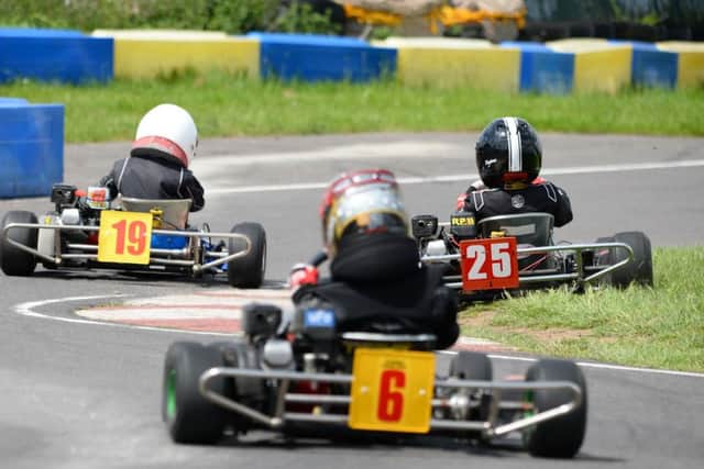 Liam Hartley (19) accelerates away in the Hondas class as Ellis Ramella (25) takes to the grass with Lucas Belt (6) giving chase EMN-160106-171604002