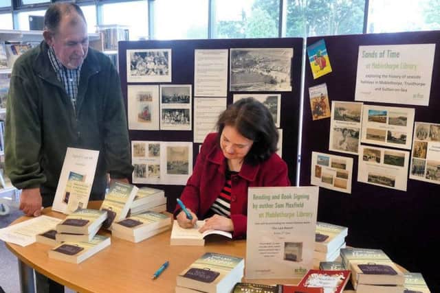 Sam Maxfield signing copies of her latest book.