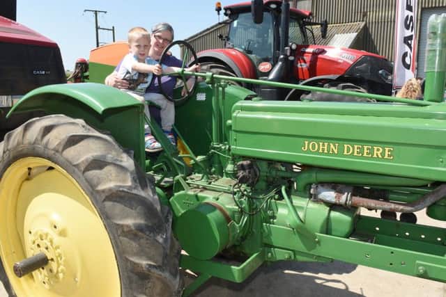 Open Farm Sunday event at Ewerby Thorpe. Oliver Odam 4 and mum Kayleigh Odam of Sleaford on a tractor. EMN-160606-152311001