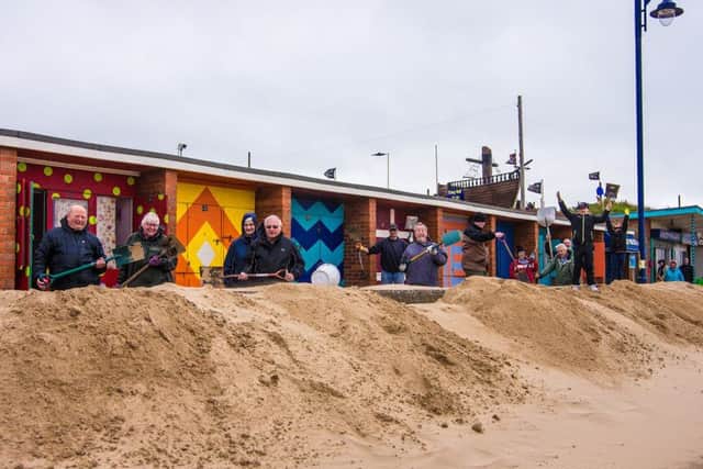Community helpers pitched in to clear the sand.