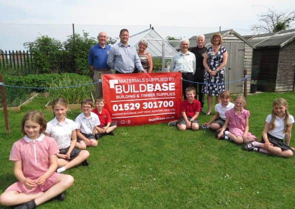 From left - Sleaford Lions Mick Lawes, Stanley Thompson and Paul Whitworth., with headteacher Laura Suffield and Rik Watson from Buildbase. Along with children: Tamsin, Freya, Thomas, James, Jacob Danielle, Hanna and Giorgina. EMN-160613-153602001