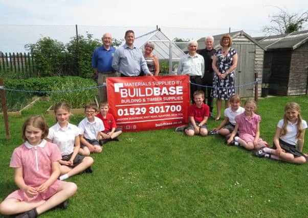 From left -  Sleaford Lions Mick Lawes, Stanley Thompson and Paul Whitworth., with headteacher Laura Suffield and Rik Watson from Buildbase. Along with children: Tamsin, Freya, Thomas, James, Jacob Danielle, Hanna and Giorgina. EMN-160613-153602001