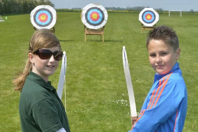Carrie Richardson (11) and Josh Rooney (10), from Humberstone, at Louth Archery Club's Have A Go day PICTURE: Ian Holmes EMN-160906-113751002