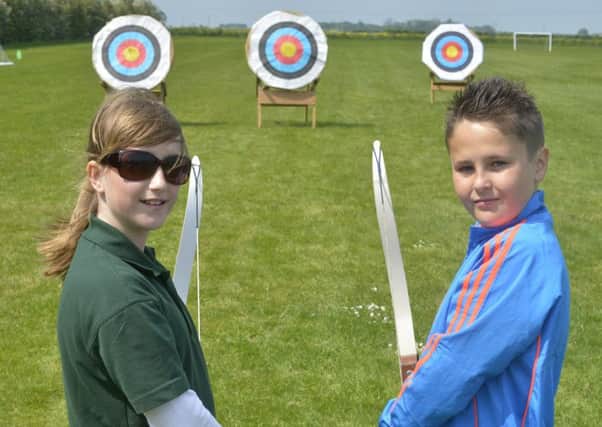 Carrie Richardson (11) and Josh Rooney (10), from Humberstone, at Louth Archery Club's Have  A Go day PICTURE: Ian Holmes EMN-160906-113751002