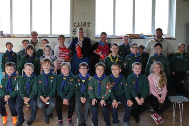 The team from Sills & Betteridge with the fire extinguishers that the group have been able to purchase with the money donated, surrounded by the 2nd Spilsby Cub Pack and their Akela, section leader Wayne Pearl, and Bagheera, assistant leader Suzy Pearl. ANL-160617-120247001
