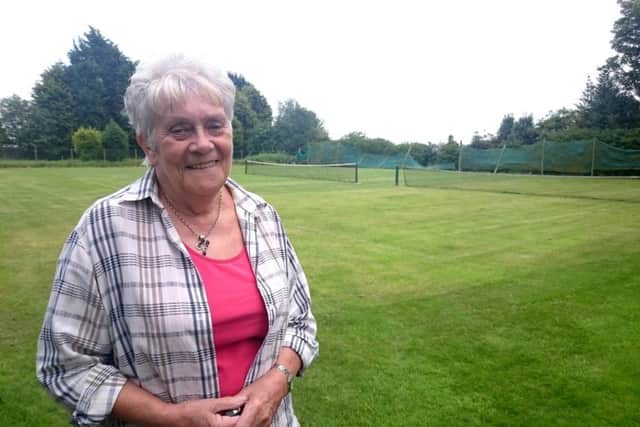 Committee members Celia Marsh at the club's three remaining grass courts.