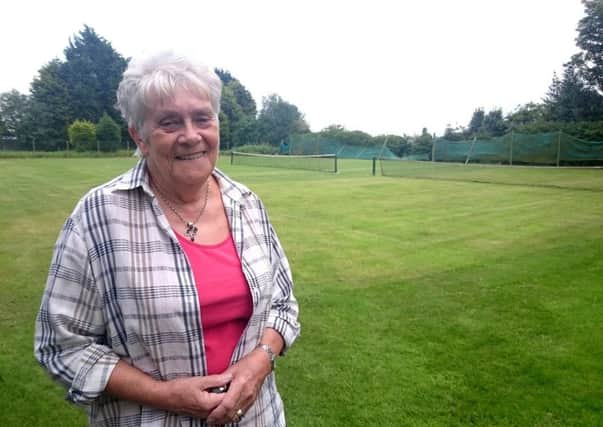 Committee members Celia Marsh at the club's three remaining grass courts.