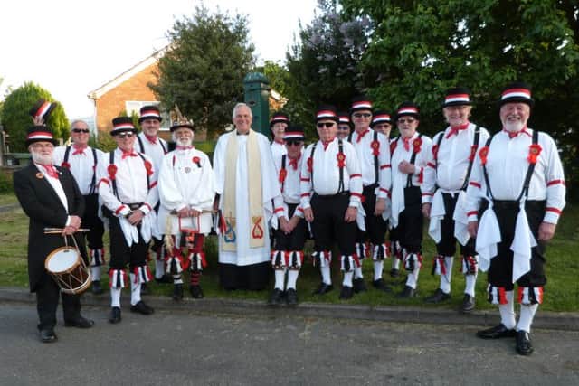 The Grimsby Morris Men posing for the camera with The Rev Geoffrey Spencer in front of the village pump. (Photo by Linda Oxley) EMN-160616-065733001