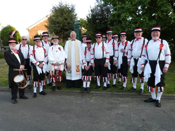 The Grimsby Morris Men posing for the camera with The Rev Geoffrey Spencer in front of the village pump.  (Photo by Linda Oxley) EMN-160616-065733001