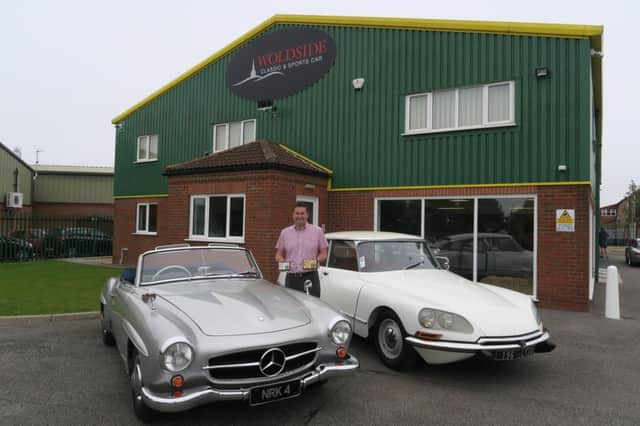 Joint owner Neil Thompson outside the new Woldside showroom with two of the winning cars