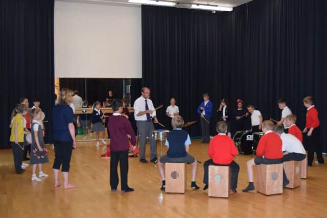 CYA Music Teacher Mr Taylor working with some of the Year 5 students EMN-160628-153728001