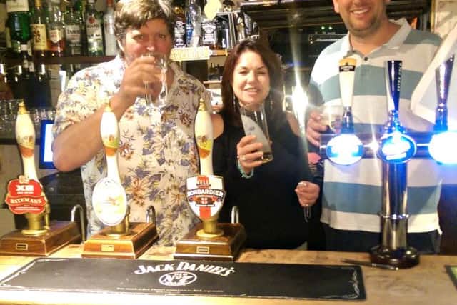 Cheers: Richard Stockdale (left) with Shirley Hargraves and Stuart Kilby behind the bar at the White Hart Inn