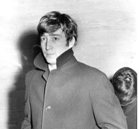 John Lennon with a worried expression shielding the sick Paul McCartney as they left Portsmouth Guildhall after the Beatles show was cancelled in November 1963. But it was re-scheduled for December of that year. PP821 EMN-160628-132542001