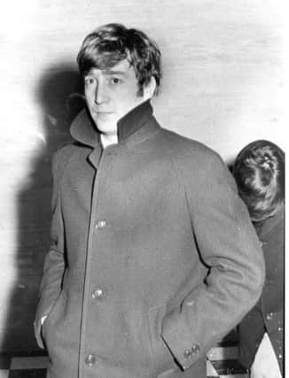 John Lennon with a worried expression shielding the sick Paul McCartney as they left Portsmouth Guildhall after the Beatles show was cancelled in November 1963. But it was re-scheduled for December of that year. PP821 EMN-160628-132542001