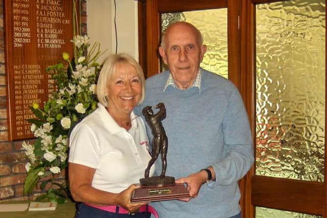Barry Frankish is seen presenting the trophy to Lady Captain Anne Wallhead.
