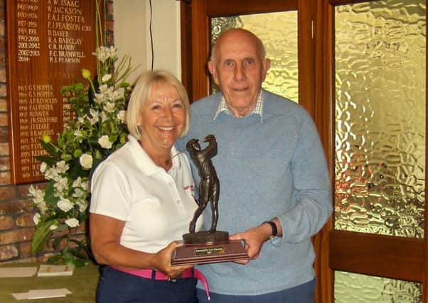 Barry Frankish is seen presenting the trophy to Lady Captain Anne Wallhead.