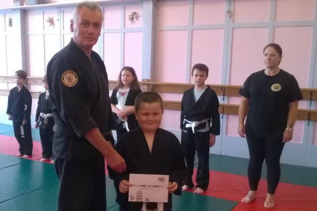 Hamish Lidgard receives his certificate.