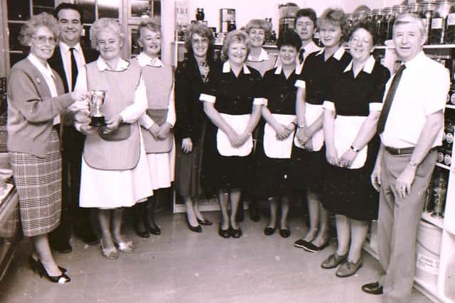 Jubilant Blanchard's staff with the cup they won at the Chamber of Commerce Service Awards. EMN-160617-143610001